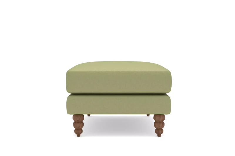 Pufa tapicerowana Amanda – ujęcie boczne z drewnianymi toczonymi nogami